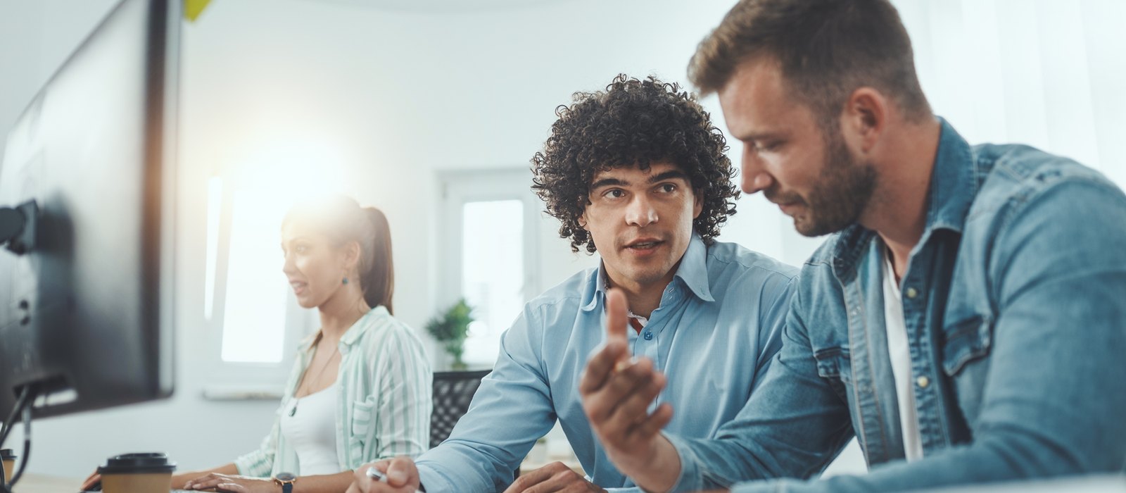 Colleagues working through a shortlist together at a computer
